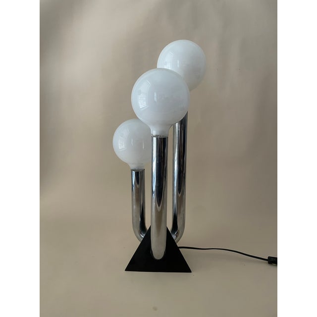 Amazing space age table or desk lamp that holds three globe bulbs. Measures 22.5” tall 7.5” wide and 7.5”deep