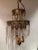 An art deco style pair of glam medium sized multi-tiered etched pot metal chandeliers having intricate decoration and lots...