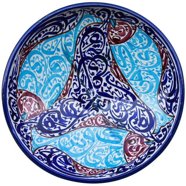 Antique handcrafted ceramic bowl hand-painted with Moorish calligraphy and a fish motif in shades of blue. Made in Fez,...