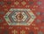Vintage handwoven Turkish kilim featuring a rich terracotta-red field with a striking arrangement of geometric medallions...