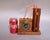 A whimsical vintage folk art desk clock designed in the form of a bundle of dynamite connected to a timing mechanism by a...