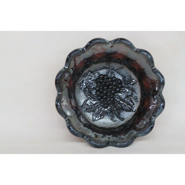 This gorgeous berry bowl is made of carnival glass. This piece features a beautiful iridescent purple color to the glass,...