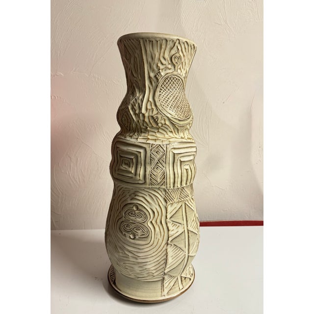 Large sgraffito carved ceramic vase with geometric detailing. This style features a primitivist aesthetic with various...
