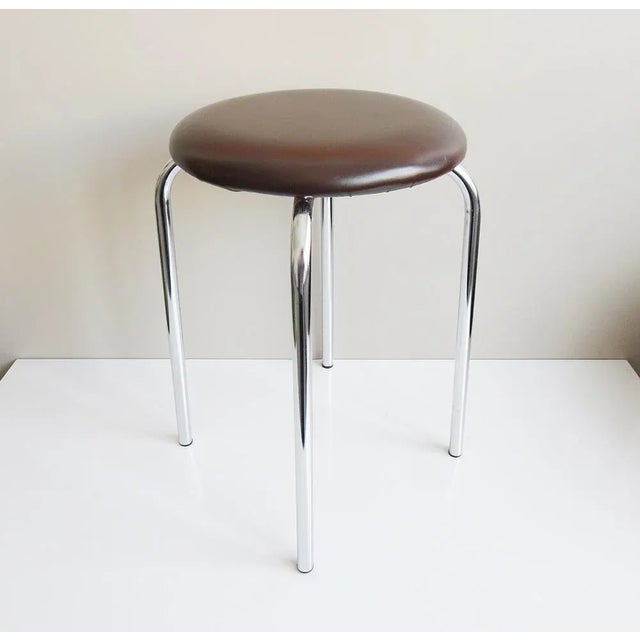 This round stool with chrome frame and brown synthetic leather cover dates from the late 1970s. The simple design language...