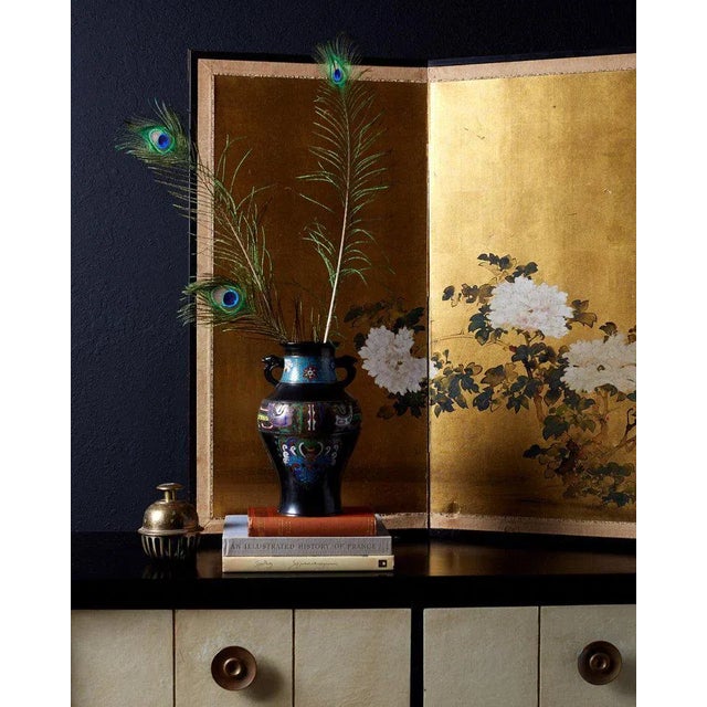 Colorful 20th century Japanese bronze champlevé vase with a vibrant enamel decoration. Adorned with zoomorphic motifs in...