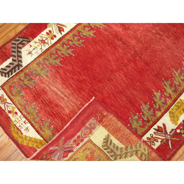 One of a kind vintage Turkish runner with an encased plain design on a red field.