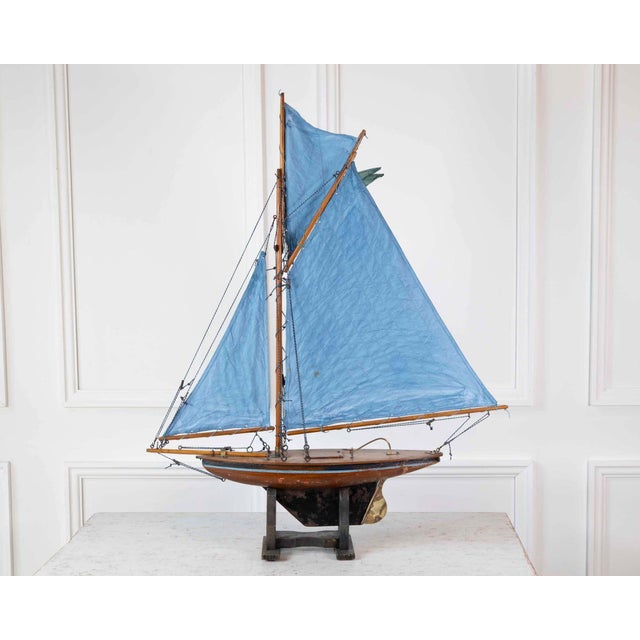 Made in England in the twentieth century, this pond yacht takes the form of a gaff-rigged cutter and is carved in wood....