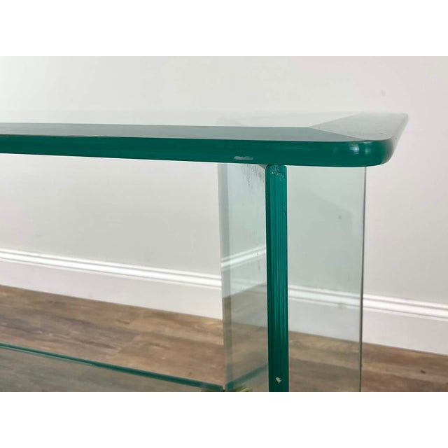 Beautiful glass console attributed to Leon Rosen for the Pace Collection. It has a subtle green tint with a beveled glass...