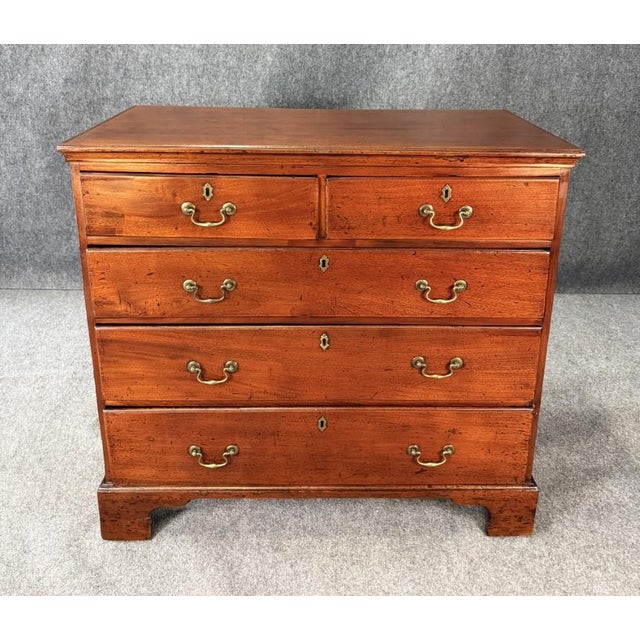 This 18th century solid mahogany chest features a timeless, understated design with a rich, warm patina and classic brass...