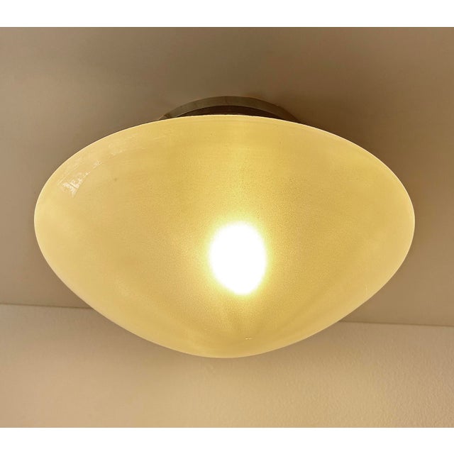 Large French Art Deco pendant light by Mazda France from the 1930s with ufo shaped glass and stepped polished aluminum...