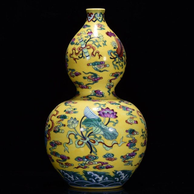 This is a vibrant, large-scale porcelain double-gourd vase (huluping), crafted in the classic Famille Rose (Fencai) style....