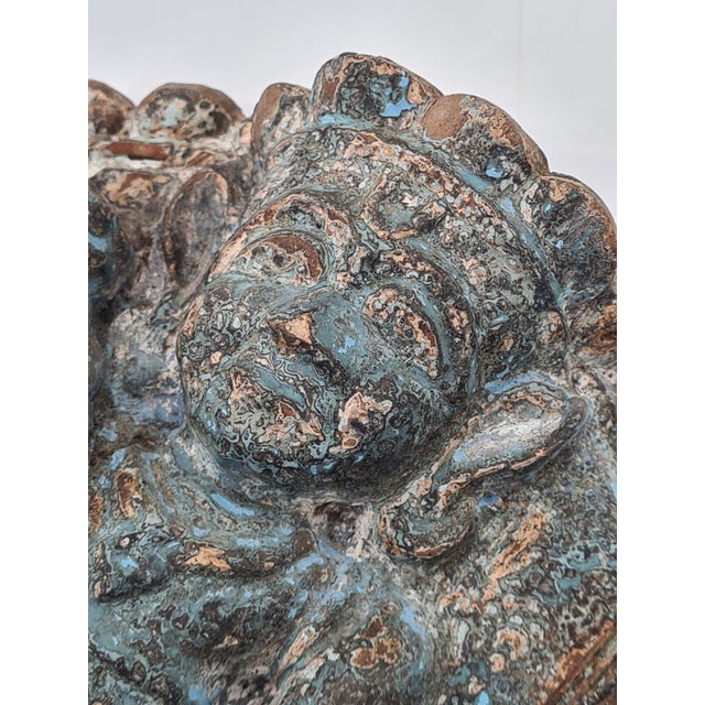 An antique, hand-carved wooden relief depicting a seated figure of a religious nature. The piece is executed in the deep-...
