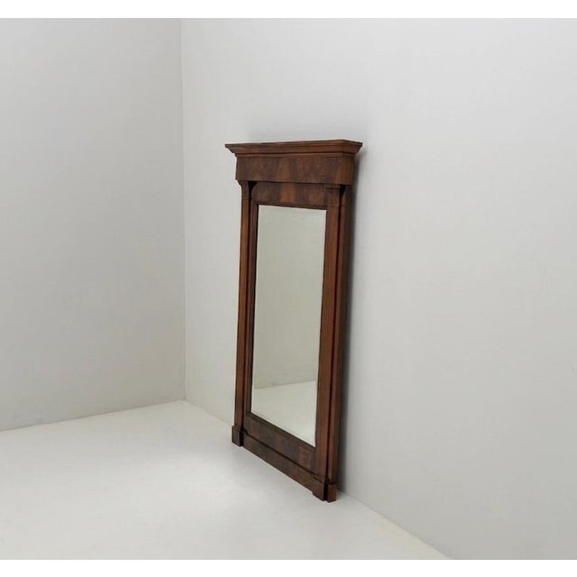The mirror is not contemporary with the frame, but more recent.