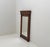The mirror is not contemporary with the frame, but more recent.