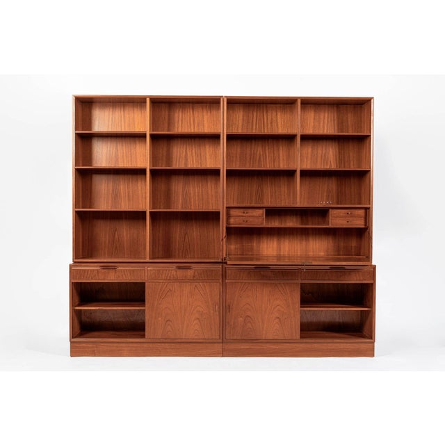 This vintage mid century Danish modern teak wood bookcase with drop-down desk by BBM Bjerringbro Møbler was made in...