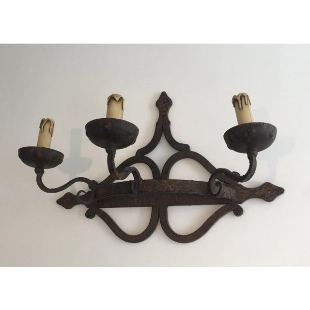 This decorative single large wall light is made of wrought iron. This is a French work, circa 1950.