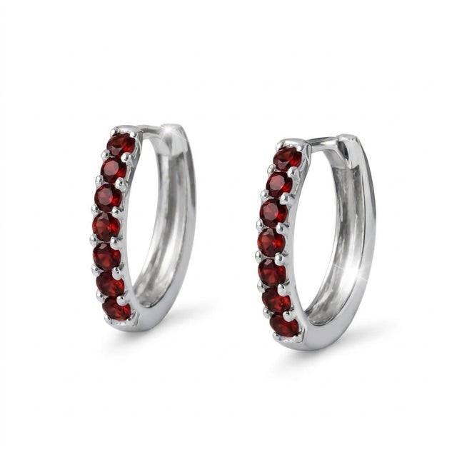 These elegant hoop earrings feature a row of rich Garnet gemstones, admired for their deep red hue and captivating...