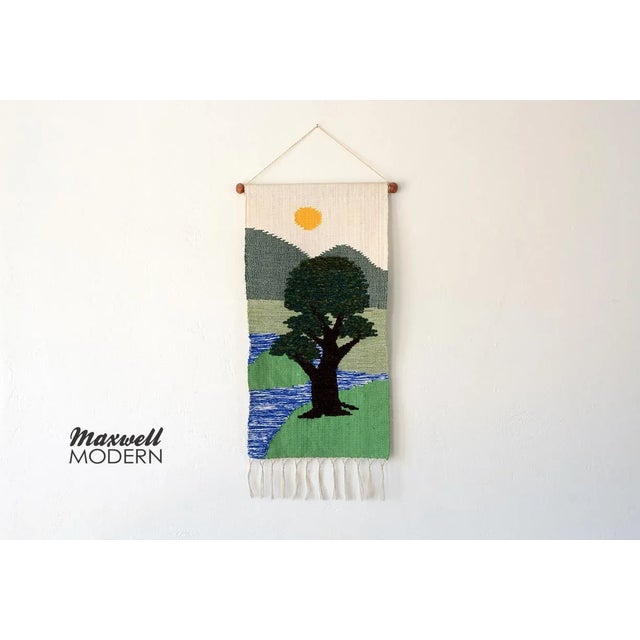 Gorgeous mid century era tapestry wallhanging depicting a calming nature scene with green pastures, mountains, river, sun...