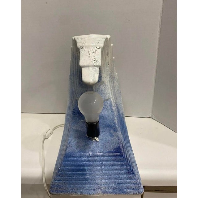 Tv lamp from the 1980s is missing light cover.