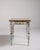 A versatile table featuring a simple design with a functional drawer for storage. The understated construction emphasizes...