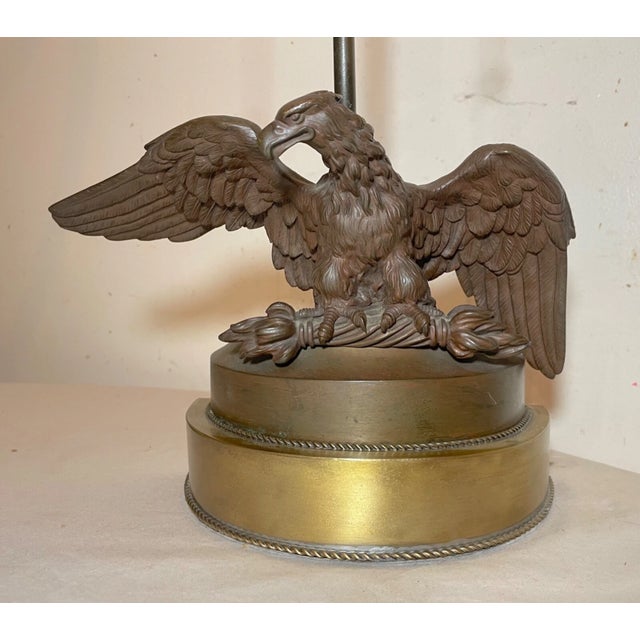 This antique patinated solid bronze American bald eagle table lamp is a stunning piece that will add a touch of...