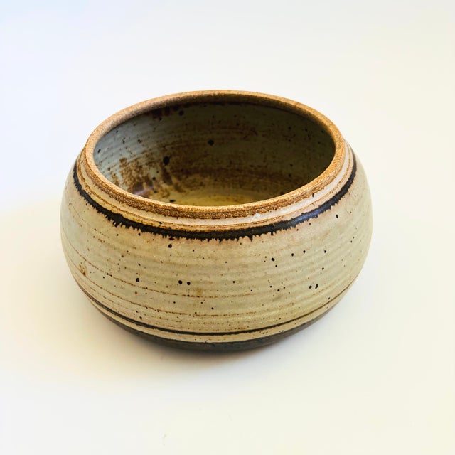 A studio pottery bowl. Speckled light gray glaze with dark brown stripes. Natural unglazed rim. A versatile size perfect...