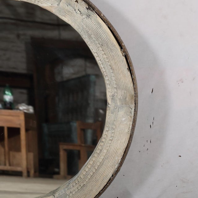 Originally a wagon wheel with an iron rim, the spokes have been removed and a mirror added to make a sophisticated rustic...
