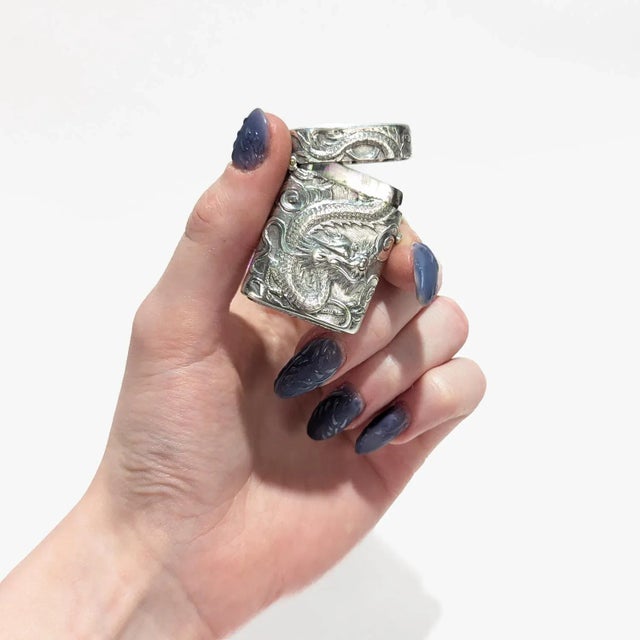 A fine antique Chinese export silver vesta or matchsafe. By Wang Hing & Co. of Hong Kong. Decorated with a dragon to one...