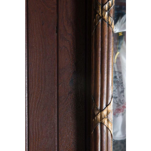 Early 20th century carved wood mirror with striking black background églomisé panels and a basket of flowers. The walnut...