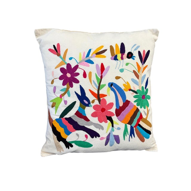 An exceptional example of Mexican Otomi embroidery textile pillow features meticulously hand-stitched imagery of a deer...