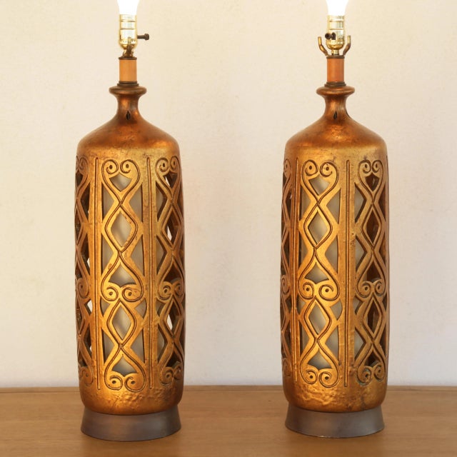Absolutely Gorgeous set of Two Large Ceramic Lamps with a beautiful deep warm golden color that catches the light in...