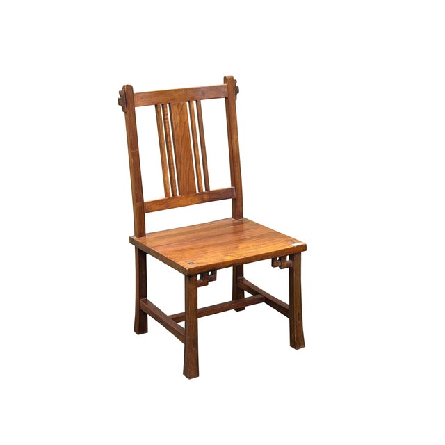 Embodying a timeless fusion of rustic warmth and architectural elegance, this striking solid wood side chair makes a...