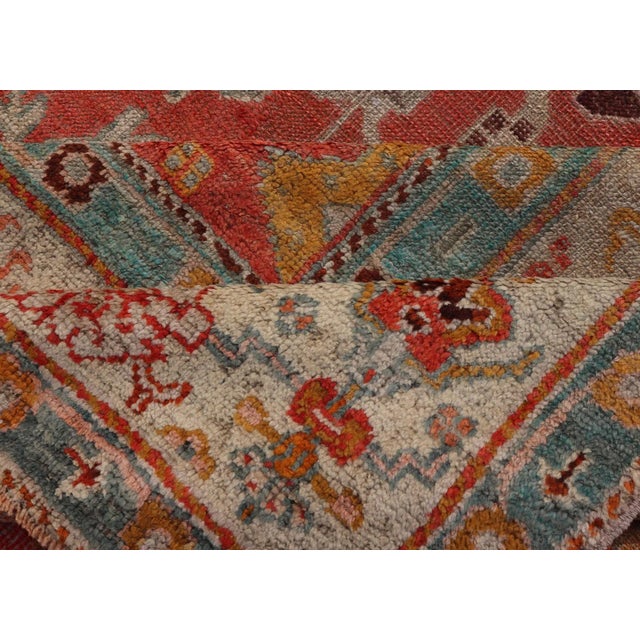 Early 20th Century Antique Turkish Oushak in Tribal Motifs in Soft Coral Blue Marigold and Cream For Sale - Image 12 of 13