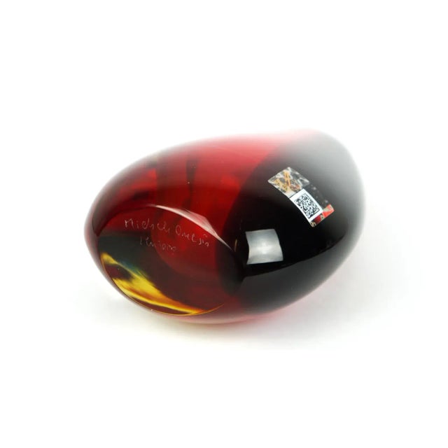 This drop-shaped vase is made of submerged blown Murano glass in transparent crystal, red, blue and amber colours. It is...