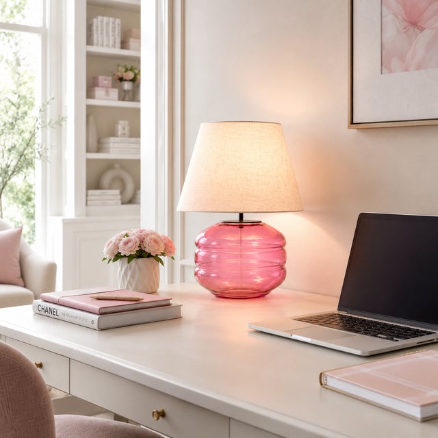 Crafted with high visual clarity, this modern table lamp features a sleek silhouette with a hand-blown glass base paired...