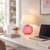 Crafted with high visual clarity, this modern table lamp features a sleek silhouette with a hand-blown glass base paired...