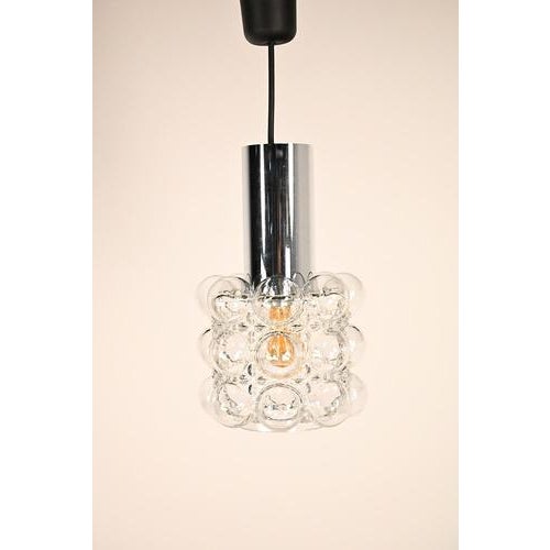 Helena Tynell pendant with chrome colored base. This Finisch designer created this lamp somewhere in the 60’s with a...