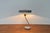 Minimalist table lamp by philips, designed by louis kalff in the 1960s. a minimalist design. The shade has a flat, disc-...