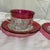 These vintage items are King's Crown pattern cups and saucers, featuring a clear thumbprint pressed glass design accented...