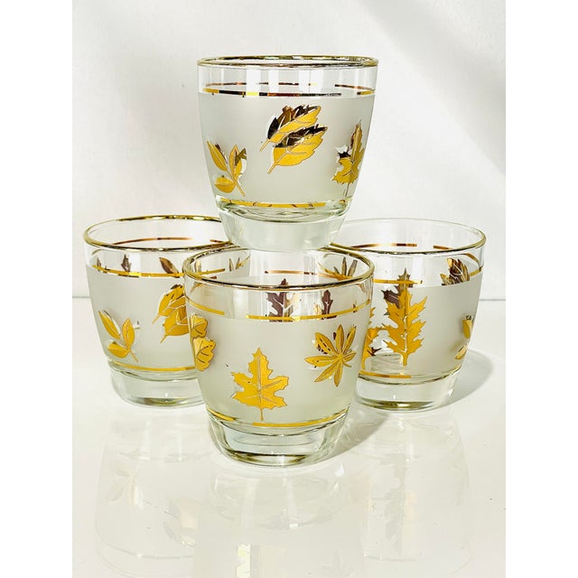 Charming set of four vintage lowball glasses featuring a classic mid-century autumn leaf motif. Each glass is decorated...