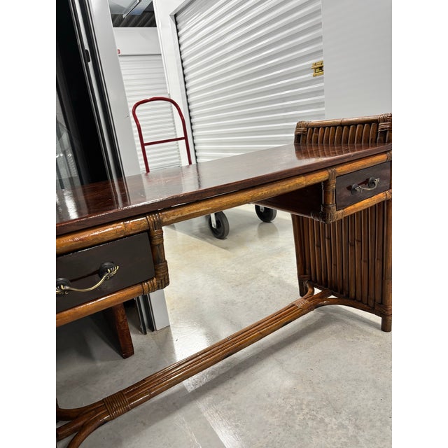 Stunning restored rattan and mahogany desk/entry table. Beautifully shellacked to enhance the charm and glow of this Paul...