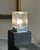 Table lamp, Italian manufacture, 1970s. Square chrome-plated metal base with a side switch, textured glass diffuser with...