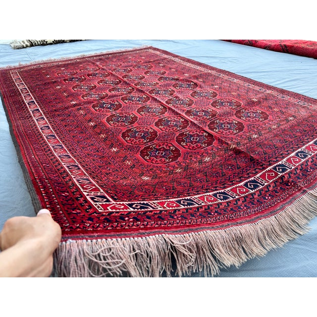 This hand-knotted Bokhara rug carries the classic Tekke gul design — rows of octagonal "elephant's foot" medallions in...