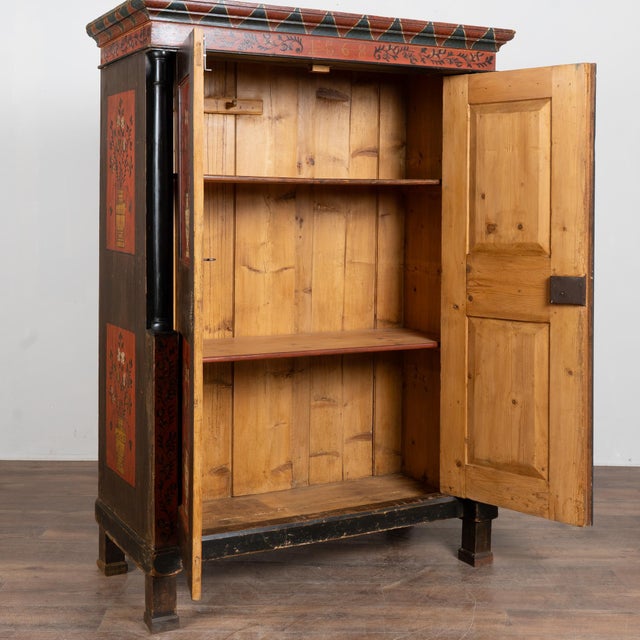 19th-century Hungarian two-door armoire crafted in pine and retaining its original hand-painted finish. The cabinet...