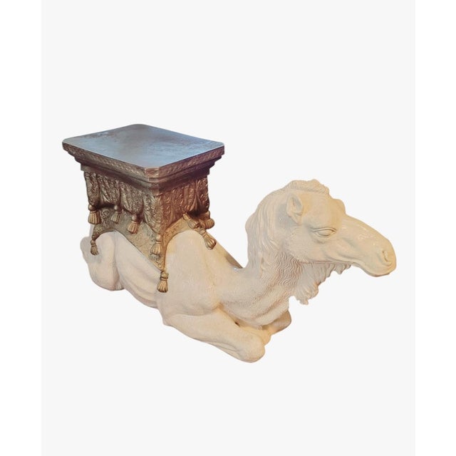 Bring a dash of global glamour and playful sophistication to your space with this captivating vintage plaster camel stool....