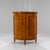 Biedermeier demi-lune cabinet veneered in birch wood, featuring two paneled doors and a simple profiled top. The interior...