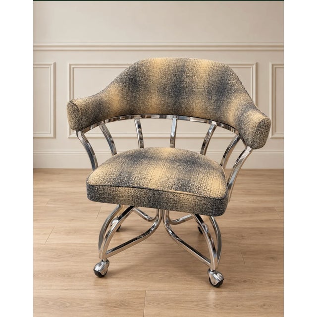 Step back into the 1970s with this incredibly unique vintage swivel chair. Blending space-age chrome with retro textile...