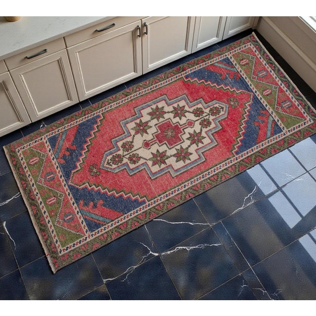 Woven in Tashpinar, Central Anatolia during the 1970s, this vintage hand-knotted small rug is an authentic village piece...