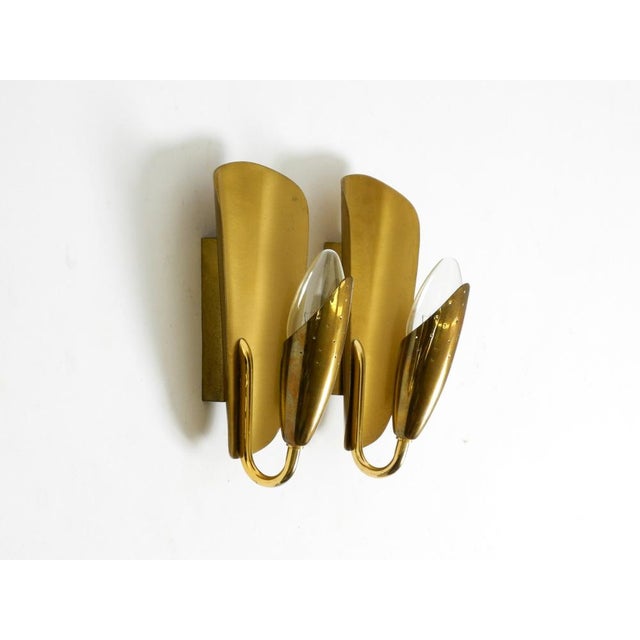 Two beautiful original Mid-Century Modern brass cone wall lamps. Typical design of the golden 1950s. Made in Sweden. The...