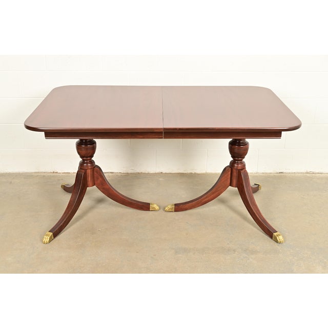 A gorgeous Georgian or Regency style double pedestal extension dining table In the manner of Baker Furniture USA, Circa...